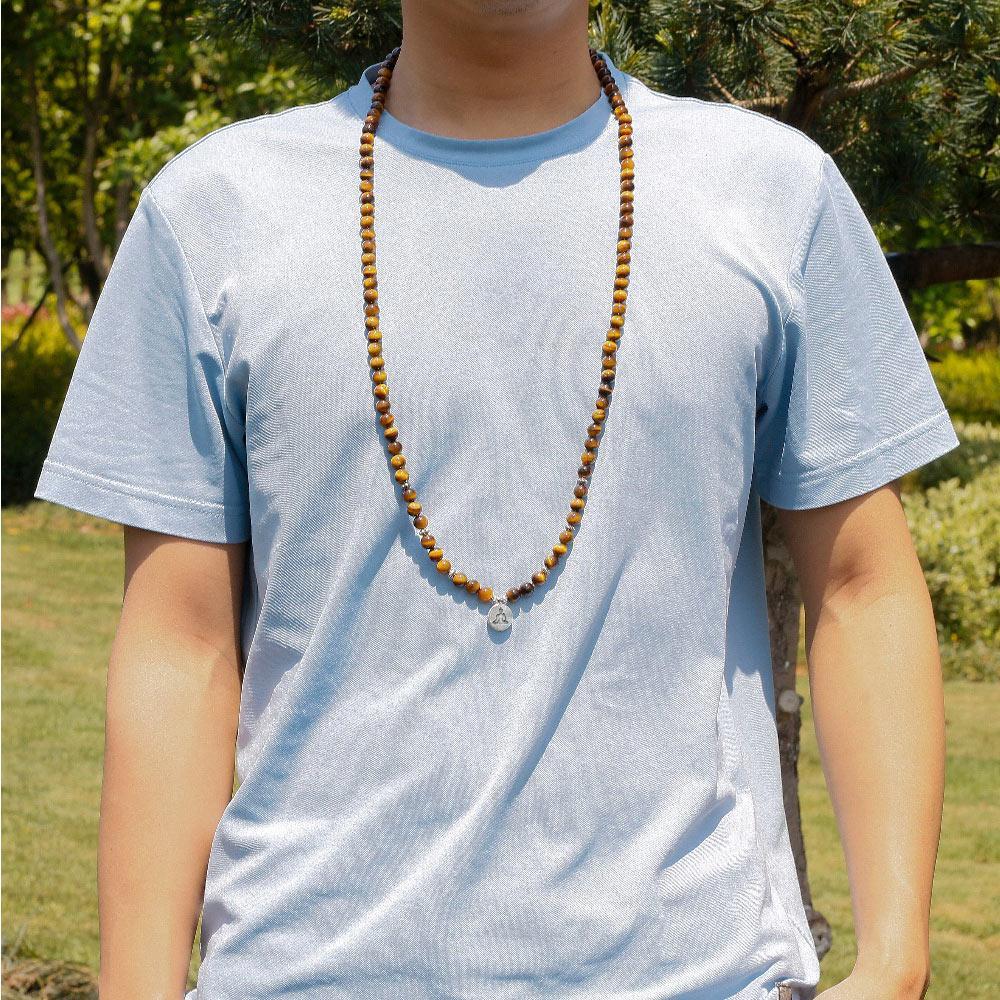 Buddha Courage 108 Mala Beads wear as necklace on man model in garden