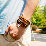 Load image into Gallery viewer, Buddha Courage 108 Mala Beads worn as bracelet by man model outside
