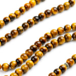 Load image into Gallery viewer, Buddha Courage 108 Mala Beads Zoomed on Natural Tiger&#39;s Eye Beads Seen from front
