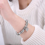 Load image into Gallery viewer, Unconditional True Love Charm Bracelet worn by a woman model
